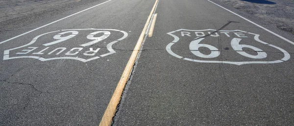 Route 66 signs on the road in Amboy, California