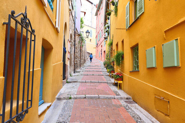 Narrow street of Menton old town, France, French Riviera.