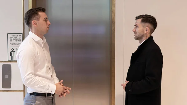 Business team group going on elevator. Business people standing near a elevator in office