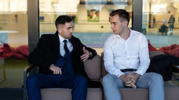 Two Businessmen Having Informal Meeting In cafe or lounge area
