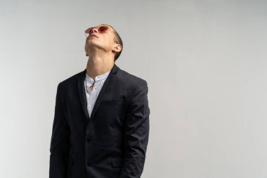 Kısayol takım elbise ve güneş gözlüğü ile karışık genç adam