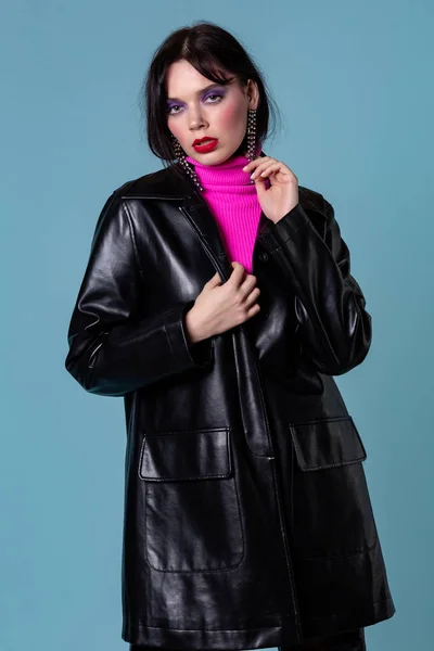 Vogue model in leather jacket with dark hair and colorful makeup