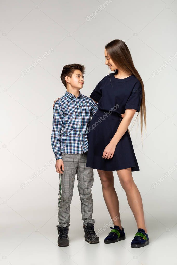 Portrait of teenagers standing on white background
