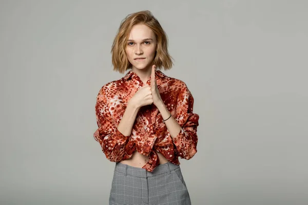 Excited cheerful european blonde girl wearing red shirt