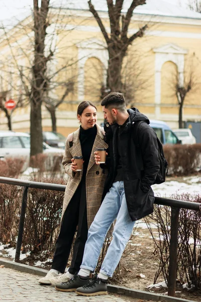 Positive couple resting after walk, drink takeaway coffe — Stock Photo, Image