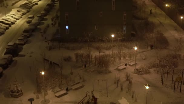 Bella nevicata di notte nel cortile di un edificio a più piani — Video Stock