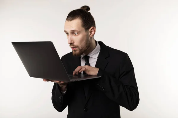 Serious bearded businessman or teacher in black suit reading post at notebook — Stock Photo, Image