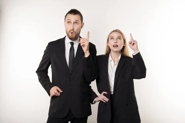 Two attractive business partners in black suits came up with an idea how to improve their business — Stock Photo, Image