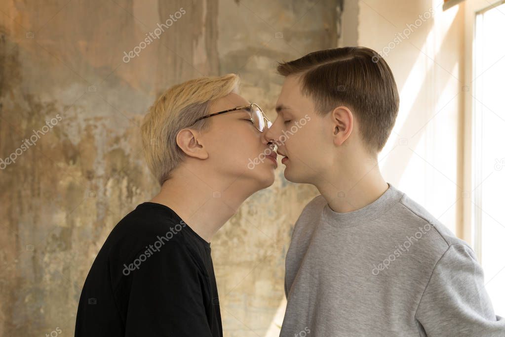 Valentines day. They love each other deeply. Two sexy international gay men kissing at home at the kitchen