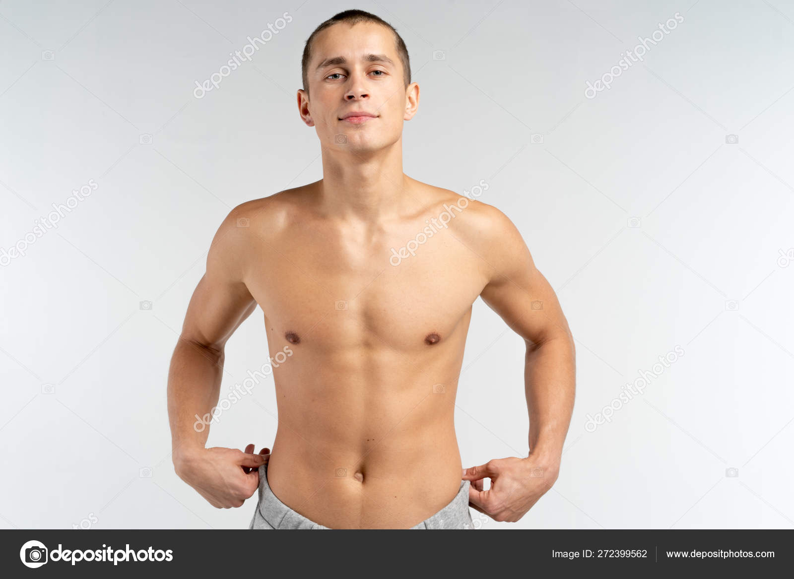 Shirtless Sporty Muscular Young Man With Short Haircut Looking At
