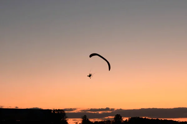 Silhouette of the hang glider that flying in the sky