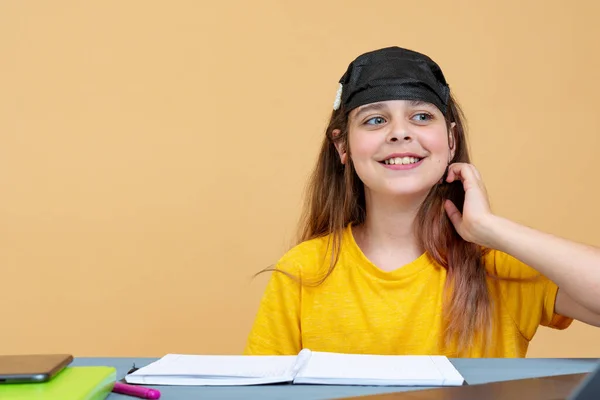 Girl in a black mask on her head works on a laptop at home in isolation. Work on remote access. Self isolation