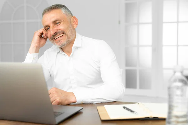 Successful businessman working on laptop in modern luxury office desk. Young entrepreneur satisfied with work result analyzing financial indicators on computer — Stock Photo, Image