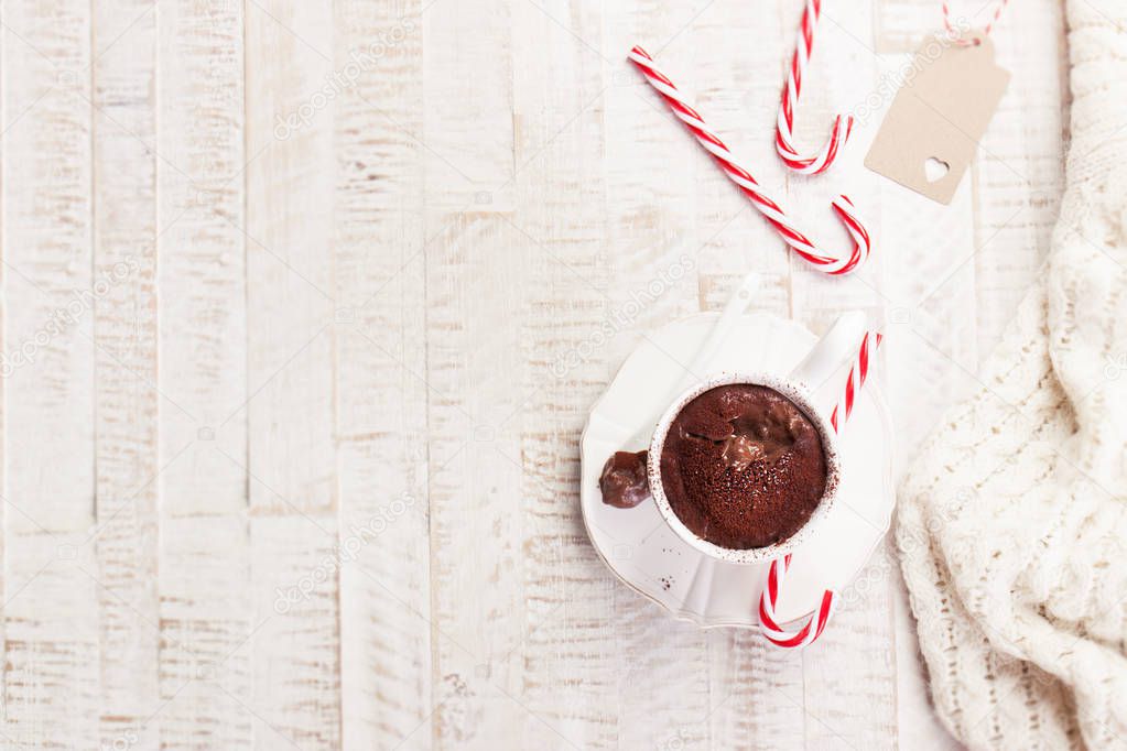 Christmas hot chocolate with cacao and candy cane, top view with copy space