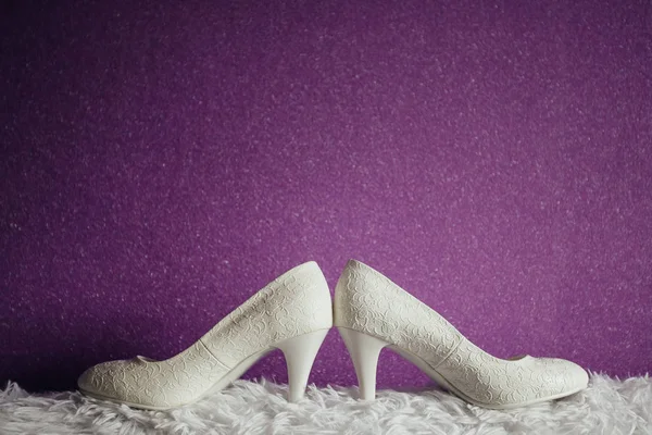 Svatební prsteny ležící na bílých botách — Stock fotografie