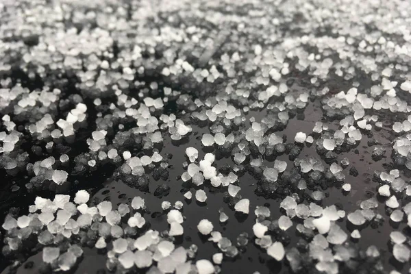 Large grains of hail on a black background. Background, texture — Stock Photo, Image