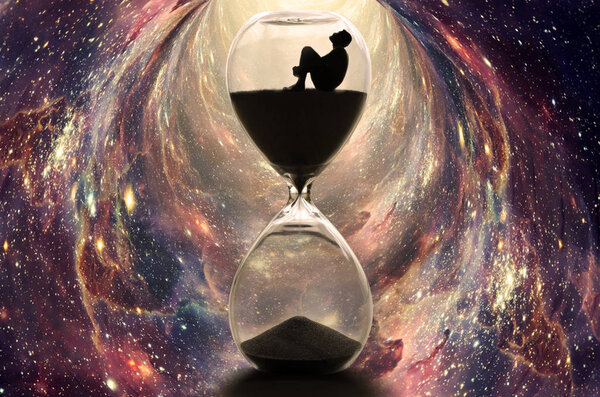 Alone man sitting in hourglass, boy looking up to the sky in the dark. Time traveling with sand watch in wormhole between galaxies