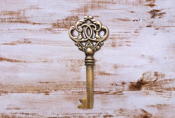 Vintage key on linen fabric. Crown shaped chest key.