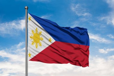 Beyaz bulutlu mavi gökyüzü karşı rüzgarda sallayarak Filipinler bayrağı. Filipin bayrağı.