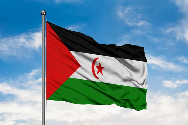 Flag Western Sahara waving in the wind against white cloudy blue sky. Western Samoan flag.
