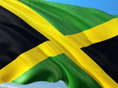 Jamaika derin mavi gökyüzü karşı rüzgarda sallayarak bayrak. Yüksek kaliteli kumaş.