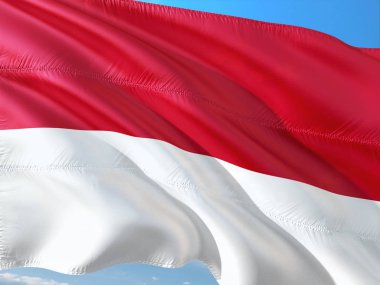 Monaco derin mavi gökyüzü karşı rüzgarda sallayarak bayrak. Yüksek kaliteli kumaş.