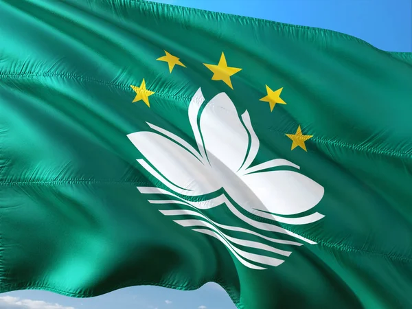 Flag of Macao waving in the wind against deep blue sky. High quality fabric.