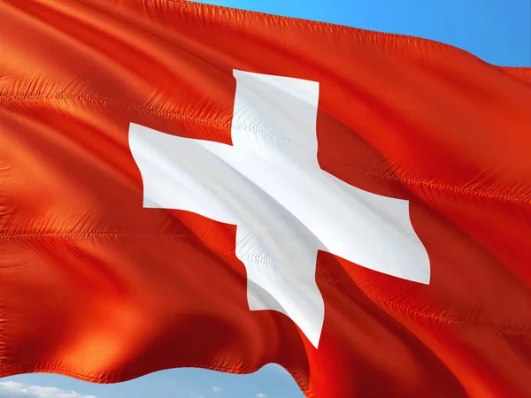 真っ青な空と風になびかせてスイス連邦共和国の旗 高品質の生地 — ストック写真