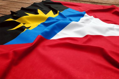 Antigua ve Barbuda bayrağı ahşap Resepsiyon arka plan üzerinde. Üstten görünüm ipek Antiguans Barbudans bayrak.