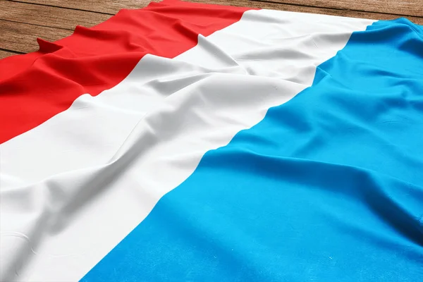在木制桌子背景上的卢森堡国旗 丝绸卢森堡标志顶部视图 — 图库照片