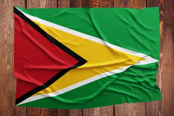 Guyanas Flagga Träbord Bakgrund Skrynkliga Guyanas Flagga Ovanifrån — Stockfoto