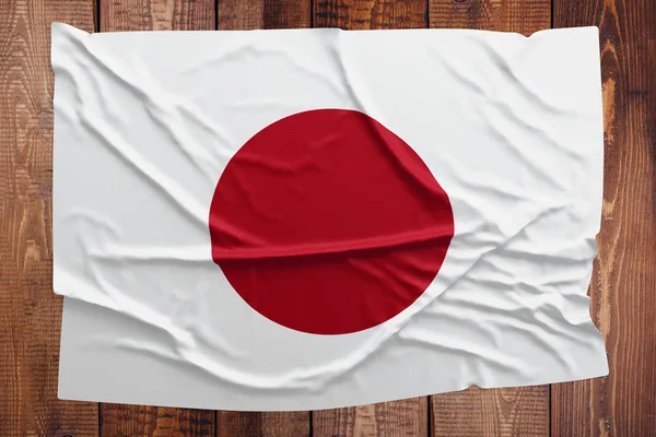 Bendera Jepang Pada Latar Belakang Meja Kayu Wrinkled Japanese Flag — Stok Foto