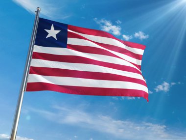 Liberya bayrağı Ulusal sallayarak güneşli mavi gökyüzü arka plan karşı kutup. Yüksek çözünürlüklü