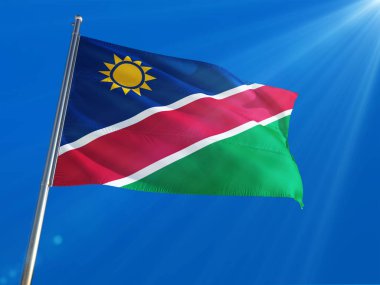 Namibya bayrak Ulusal sallayarak derin mavi gökyüzü arka plan karşı kutup. Yüksek çözünürlüklü