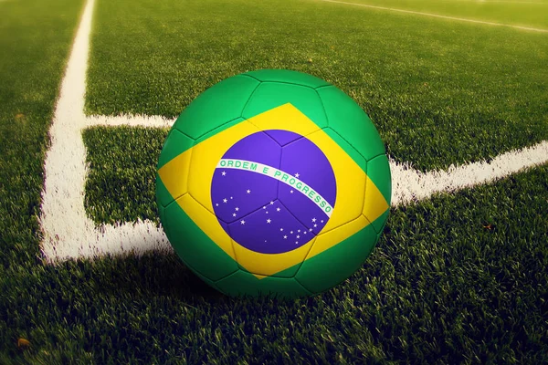 Brazil ball on corner kick position, soccer field background. National football theme on green grass.