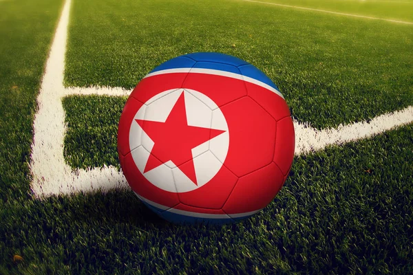 North Korea ball on corner kick position, soccer field background. National football theme on green grass.