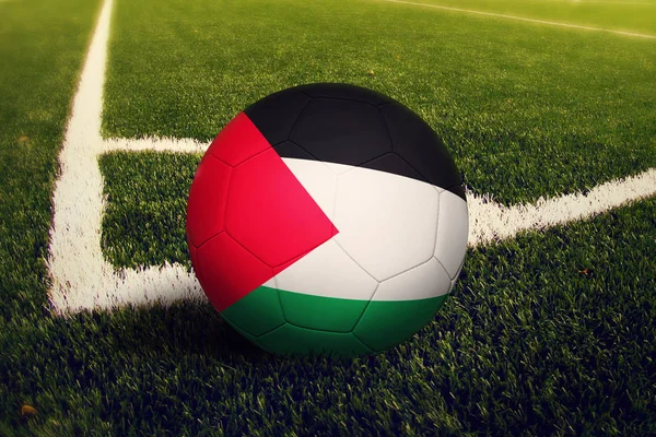 Palestine ball on corner kick position, soccer field background. National football theme on green grass.