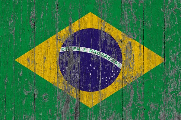 Flag of Brazil painted on worn out wooden texture background.