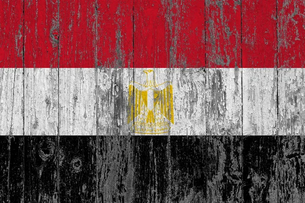 Flag of Egypt painted on worn out wooden texture background.