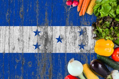 Fresh vegetables from Honduras on table. Cooking concept on wooden flag background. clipart