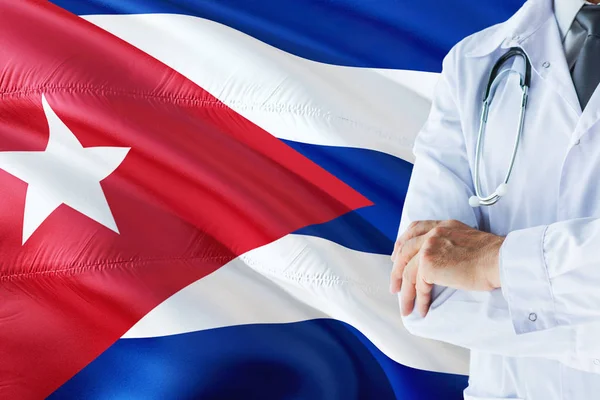 Cuban Doctor standing with stethoscope on Cuba flag background. National healthcare system concept, medical theme.