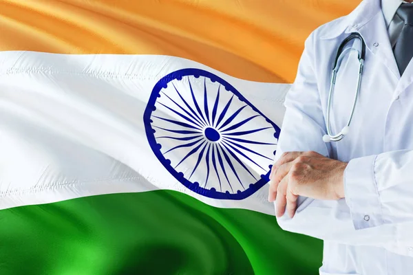 Indian Doctor standing with stethoscope on India flag background. National healthcare system concept, medical theme.