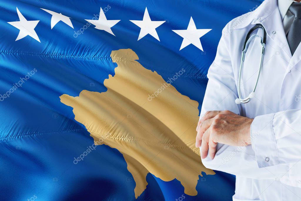Doctor standing with stethoscope on Kosovo flag background. National healthcare system concept, medical theme.