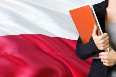 Lehçe dil kavram öğrenme. Polonya bayrağı arka planda duran genç kadın. Kitaplar, turuncu boş kitap kapağı tutan öğretmen.