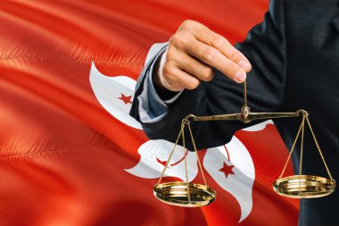 Yargıç adaletin altın terazisi ile Hong Kong bayrağı arka plan sallayarak tutuyor. Eşitlik Tema ve yasal kavram.