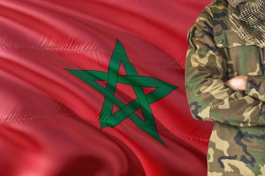 Crossed arms Moroccan soldier with national waving flag on background - Morocco Military theme. clipart