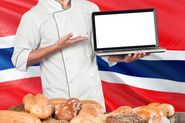 Baker dizüstü Bouvet Adaları bayrağı ve ekmek arka plan üzerinde tutarak. Şef giyen üniforma işaret boş ekran kopya alanı için.