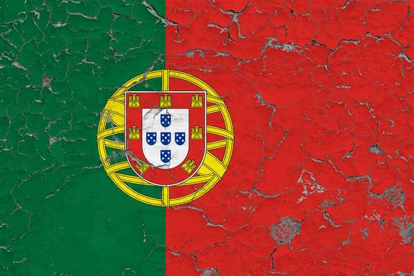 Flag of Portugal painted on cracked dirty wall. National pattern on vintage style surface.