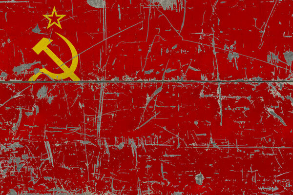 Grunge Soviet Union flag on old scratched wooden surface. National vintage background.