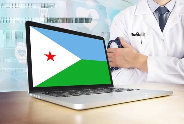 Djibouti healthcare system in tech theme. Flag on computer screen. Doctor standing with stethoscope in hospital. Cryptocurrency and Blockchain concept.